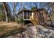 Exterior view of a brick house with a screened porch and wooden steps leading to a paved walkway at 1825 Hyatt Ave, Rock Hill, SC 29732