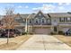 View of townhouse with long driveway and well-maintained lawn and landscape at 1905 Fleetwood Dr, Charlotte, NC 28208