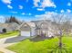 Two-story home boasts a well-manicured lawn and a two-car garage in a sunny neighborhood at 191 Pleasant Grove Ln, Mooresville, NC 28115