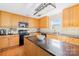 Traditional-style kitchen with wooden cabinetry, granite counters, stainless steel appliances, and a central island at 191 Pleasant Grove Ln, Mooresville, NC 28115