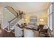 Inviting living room featuring a staircase, comfortable seating, and soft, neutral color palette at 2010 Nolen Park Ln, Charlotte, NC 28209