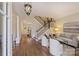 Elegant living room boasts hardwood floors, a staircase, decorative chandelier, and neutral decor at 2010 Nolen Park Ln, Charlotte, NC 28209