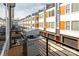 Balcony view showcases a stainless steel gas grill, row of townhomes, and individual garages below at 2014 Bryant Park Dr, Charlotte, NC 28208