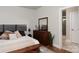 Bedroom featuring wood floors, a large dresser with mirror, and a doorway to an ensuite bathroom at 2014 Bryant Park Dr, Charlotte, NC 28208