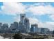 View of the Charlotte city skyline with various buildings and structures under a cloudy sky at 2014 Bryant Park Dr, Charlotte, NC 28208