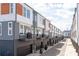 Exterior view of new townhomes with gray siding, wood panels, garages, and small balconies at 2014 Bryant Park Dr, Charlotte, NC 28208