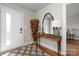 Inviting foyer features a decorative table, mirror, lamp, and a patterned rug by the front door at 2014 Bryant Park Dr, Charlotte, NC 28208