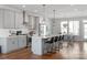 Modern kitchen features gray cabinets, stainless steel appliances, an island with barstool seating, and an adjacent dining area at 2014 Bryant Park Dr, Charlotte, NC 28208