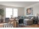 Comfortable living room featuring a sectional sofa, accent chairs, modern rug, and large windows with natural light at 2014 Bryant Park Dr, Charlotte, NC 28208