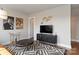 Stylish living room featuring a unique patterned rug, contemporary decor, and a flat-screen TV on a modern console at 2014 Bryant Park Dr, Charlotte, NC 28208