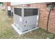 A newly installed air conditioner unit rests next to a vintage brick exterior at 2204 W Second Ave, Gastonia, NC 28052