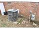 Shot of air conditioner unit, brick veneer, utility access, and foliage at 2204 W Second Ave, Gastonia, NC 28052