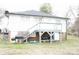 The back of the house shows a wooden deck, stairs, and access to the ground floor at 2204 W Second Ave, Gastonia, NC 28052