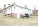 View of the rear of this charming home, featuring a quaint deck and brick foundation at 2204 W Second Ave, Gastonia, NC 28052
