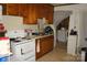 Functional kitchen with classic cabinetry, a white appliance package, and a view to laundry room at 2204 W Second Ave, Gastonia, NC 28052