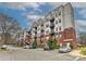 Modern condo building with brick and steel, featuring private balconies and ample parking at 2338 Yadkin Ave # 205, Charlotte, NC 28205
