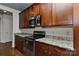 Kitchen featuring granite countertops, stainless steel appliances, and dark wood cabinets at 2338 Yadkin Ave # 205, Charlotte, NC 28205