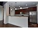 Open kitchen with stainless steel appliances and breakfast bar overlooking the living area at 2338 Yadkin Ave # 205, Charlotte, NC 28205