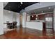 Open-concept living and kitchen area featuring stained concrete floors and industrial-style ceilings at 2338 Yadkin Ave # 205, Charlotte, NC 28205
