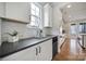 Bright kitchen featuring white cabinets, granite counters, stainless appliances, and stylish backsplash at 261 Helton Ln, Fort Mill, SC 29708