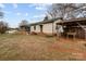 Backyard of the home featuring green grass, a lawn mower, and a small outdoor storage shed at 2845 Wood Gate Rd, Lincolnton, NC 28092