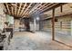 Unfinished basement featuring exposed ceiling beams, a concrete floor, and shelving at 2845 Wood Gate Rd, Lincolnton, NC 28092