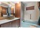 Bathroom featuring a blue bathtub, mirror, sink, and vanity with a storage cabinet at 2845 Wood Gate Rd, Lincolnton, NC 28092