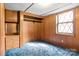 Bedroom featuring wooden paneling, built in storage, and a window for natural light at 2845 Wood Gate Rd, Lincolnton, NC 28092