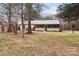 Charming single-story home featuring a screened porch, metal roof, and mature trees on a spacious lot at 2845 Wood Gate Rd, Lincolnton, NC 28092
