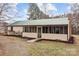 View of the side of the house featuring a screened porch and a metal roof in a rural area at 2845 Wood Gate Rd, Lincolnton, NC 28092