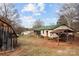 Charming home featuring a green roof, screened porch, and rustic outbuildings, set on a spacious lot at 2845 Wood Gate Rd, Lincolnton, NC 28092