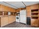Kitchen featuring wood cabinets, updated flooring, white appliances, and window with diamond panes at 2845 Wood Gate Rd, Lincolnton, NC 28092