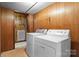 Laundry room with white washer and dryer units next to a doorway to another room at 2845 Wood Gate Rd, Lincolnton, NC 28092