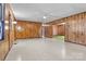 Spacious living room featuring wood paneled walls, vintage light fixtures, and a large window at 2845 Wood Gate Rd, Lincolnton, NC 28092