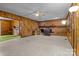 Living room with a brick fireplace, wood paneling and vintage decor creates a cozy ambiance at 2845 Wood Gate Rd, Lincolnton, NC 28092