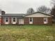 Charming single-story brick home featuring cozy curb appeal and an inviting front yard at 3003 Winston Nw Dr, Concord, NC 28027