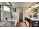 Bright bathroom featuring a glass enclosed shower, soaking tub, double sinks, and dark wood cabinets at 3542 Rapport Ct # 37, Lancaster, SC 29720