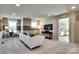 A comfortable living room with carpet, a white couch, a TV and a view of a bedroom at 3542 Rapport Ct # 37, Lancaster, SC 29720