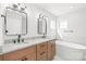 Bathroom featuring double vanity with granite countertops and marble tile at 3646 46Th Ne Ave, Hickory, NC 28601