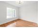Bright room with hardwood floors, a ceiling light, and a large window at 3646 46Th Ne Ave, Hickory, NC 28601