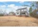 Rear view of two-story home with covered porch and large backyard, highlighting its outdoor charm at 3646 46Th Ne Ave, Hickory, NC 28601