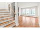Open-concept living space with beautiful wood floors, bright natural light, and modern staircase at 3646 46Th Ne Ave, Hickory, NC 28601