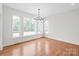 Bright living room featuring hardwood floors, large windows, and modern chandelier at 3646 46Th Ne Ave, Hickory, NC 28601