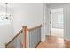 Staircase with modern black iron spindles and natural wood railing at 3646 46Th Ne Ave, Hickory, NC 28601