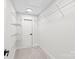 Bright walk-in closet with clean, white walls, carpeted floor, wire shelving, and a door at 3646 46Th Ne Ave, Hickory, NC 28601