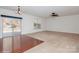 Spacious living room featuring hard wood floors, neutral carpet, and sliding glass door to the patio at 420 Augustus Ln, Mount Holly, NC 28120