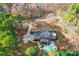 Aerial view showcases the property's pool, landscaping, sunroom, and surrounding trees at 491 Stonemarker Rd, Mooresville, NC 28117