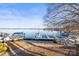 Picturesque view of a boat dock on a calm lake, featuring multiple boats and clear blue skies at 491 Stonemarker Rd, Mooresville, NC 28117