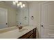 Bathroom featuring vanity with long countertop, mirror, neutral color scheme, and modern lighting at 5002 Stonehill Ln, Matthews, NC 28104