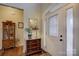 Inviting foyer showcasing hardwood floors, a decorative chest, and a detailed mirror, creating a warm first impression at 5002 Stonehill Ln, Matthews, NC 28104